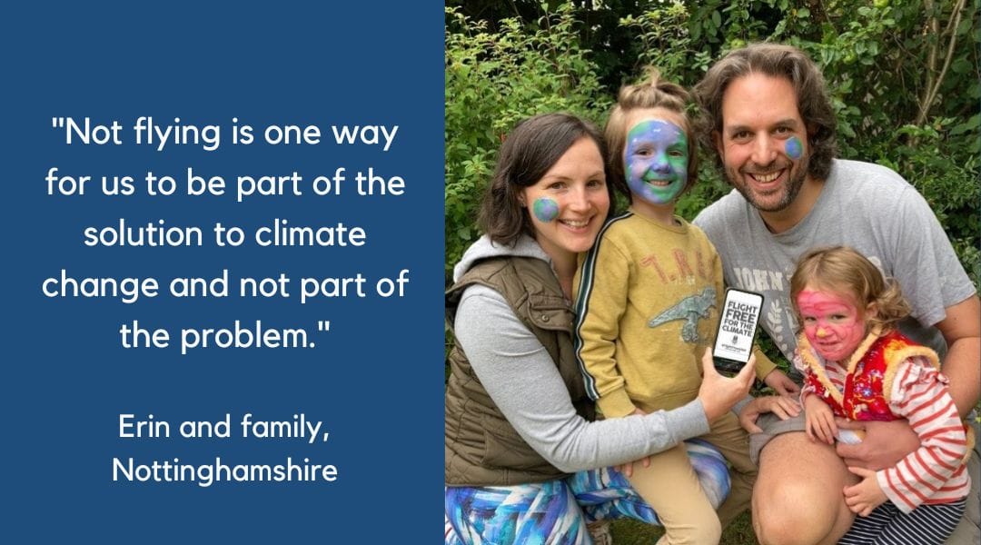 Image shows a couple kneeling down outside with their two children holding a phone that says flight free for the climate on the screen. Both parents have brown hair. All four of them have their faces painted, Erin and her partner have small planet Earths on their cheeks, their son has the Earth painted to cover his face and their daughter has pink face paint.