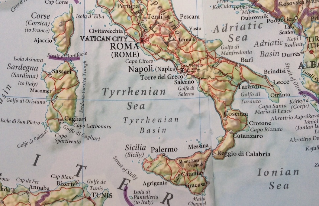 The picture shows a closeup shot of a map of Italy, with Sicily at the bottom. 