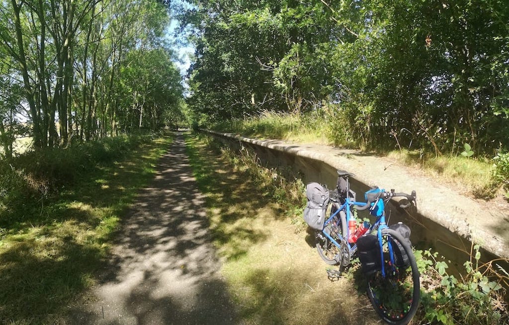 Image shows Alastair's bicycle leaning up against the platform of an old railway line